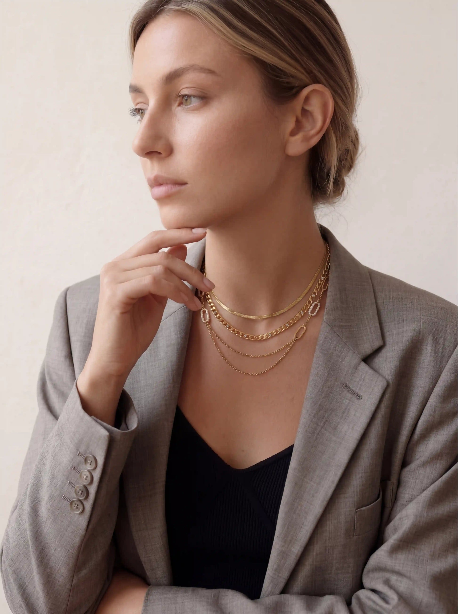 Elegant woman wearing delicate double strand gold necklace with crystal accents everyday essential.