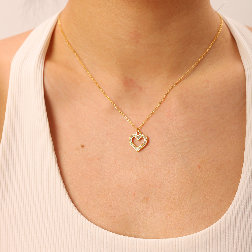 A beautiful close-up of The Devotion Necklace resting on a model's collarbone, highlighting its delicate size and brilliant sparkle for everyday wear.