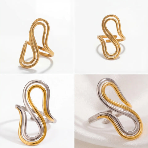 Aesthetic product photography of gold and two-tone sculptural rings on marble.