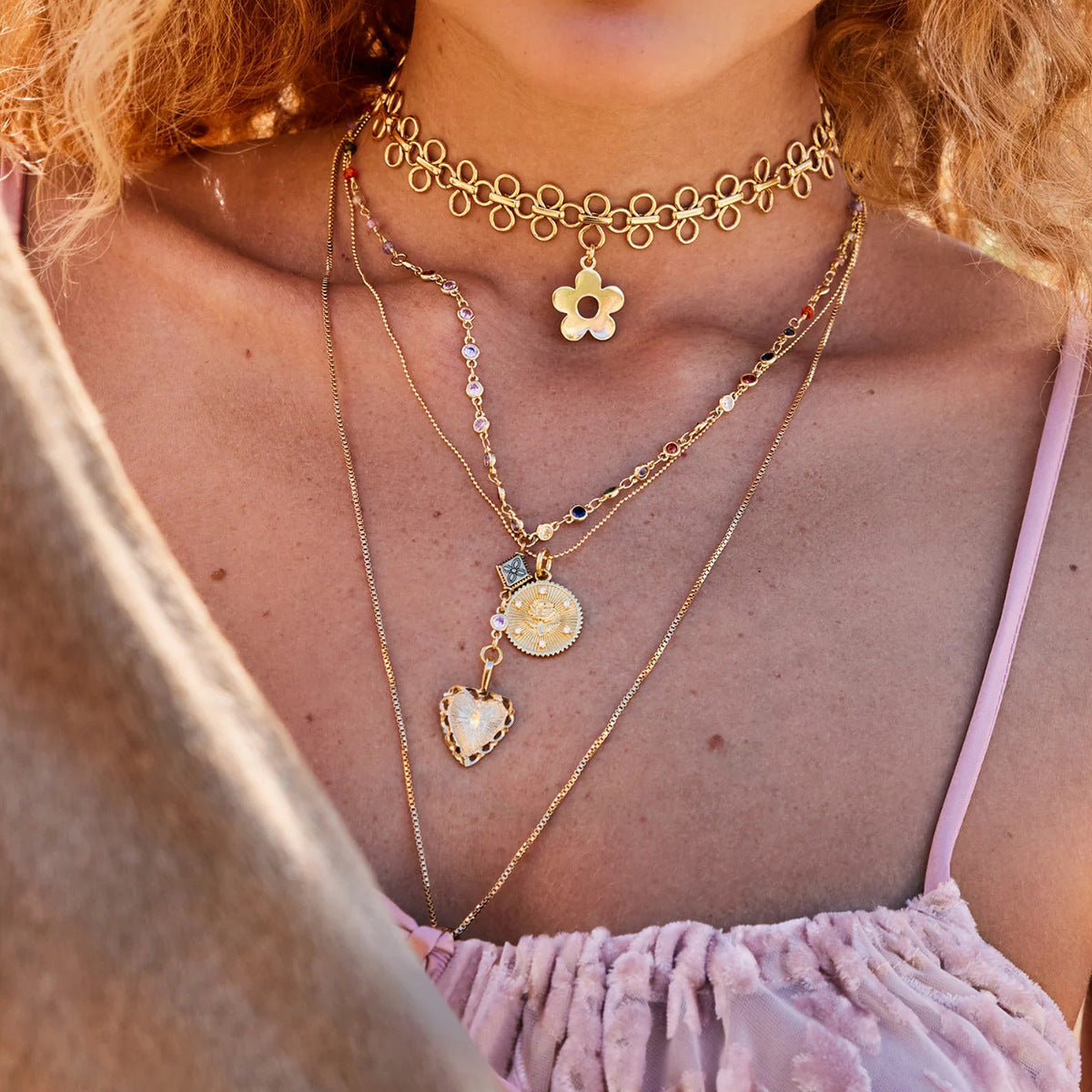 A model showcasing the versatility of The Elodie Choker by wearing it as the perfect top layer in a stylish, multi-layered necklace stack.