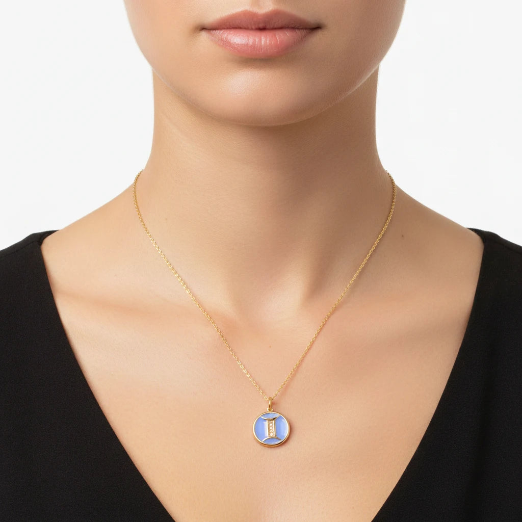 Woman wearing blue enamel zodiac pendant necklace with black outfit everyday style.