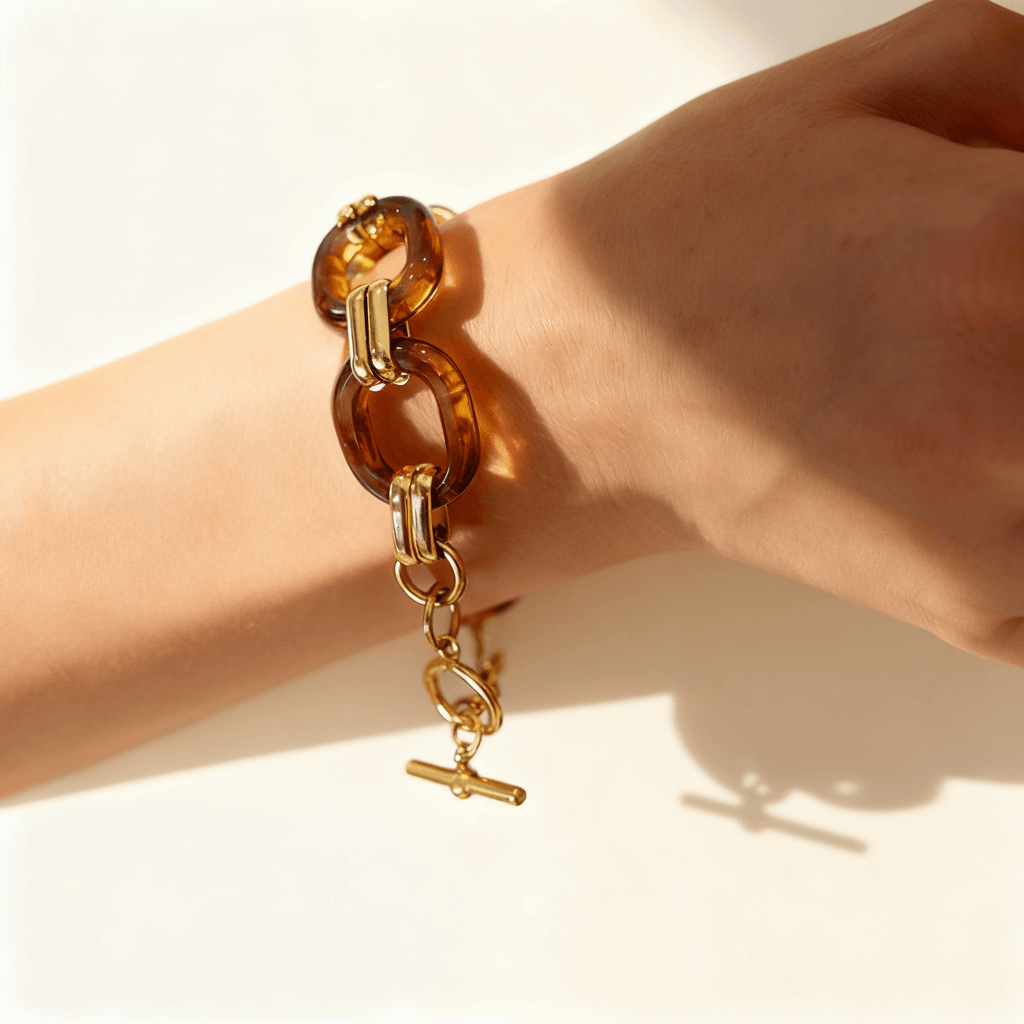 Close-up of a model's wrist wearing the Florence Link Bracelet, demonstrating the scale of the chunky links and how the gold toggle clasp sits elegantly.