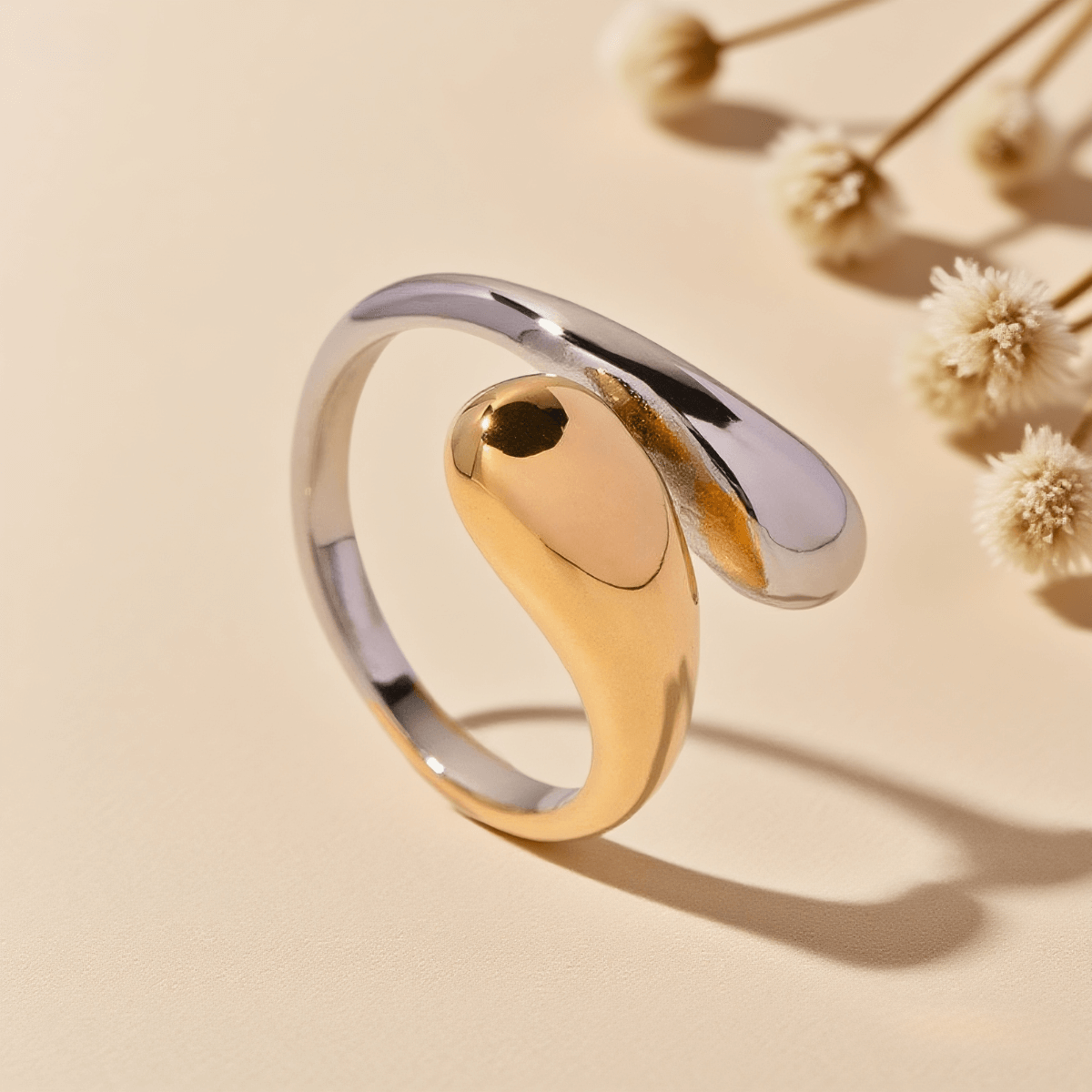 Fluid Pebble Ring — sculptural pebble wrap ring in gold/silver finish, polished and elegant.