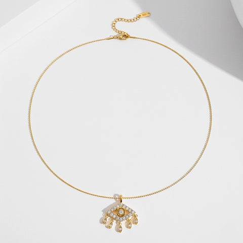A full view of The Fortuna Necklace laid out in a circle on a clean white background, showing the entire length of the delicate ball chain and adjustable clasp.