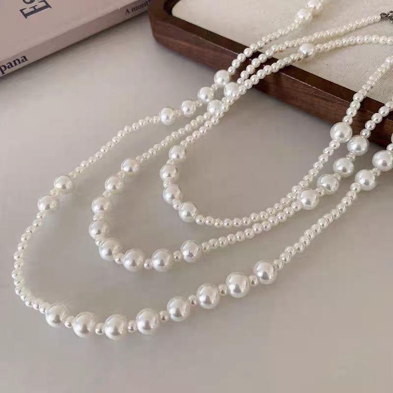 A close-up of The Gabrielle Necklace laid out to show the beautiful variation in pearl sizes, creating a rich and dynamic texture.