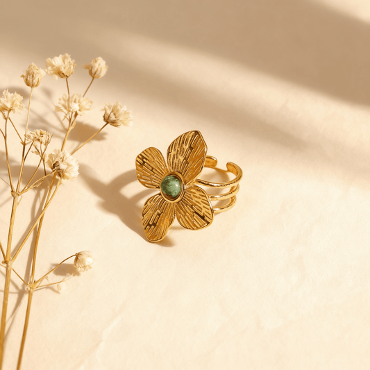 An extreme close-up of a single petal on the Gaia Ring. The image details the intricate, hammered texture of the gold surface, showcasing the artisanal craftsmanship and the way it beautifully catches and diffuses light.