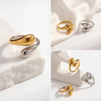 Aesthetic product photography of gold silver and two-tone Gemini rings on white stone.