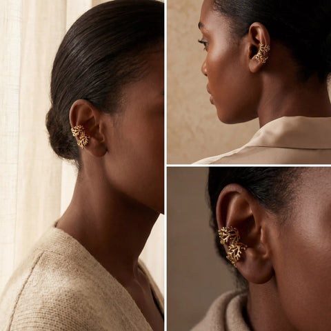 Model with dark skin wearing gold cartilage ear cuff side profile view.