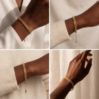 Model with dark skin wearing gold mesh wristband simple everyday jewelry.