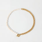 Asymmetrical pearl and gold curb chain necklace with front toggle clasp waterproof jewelry.