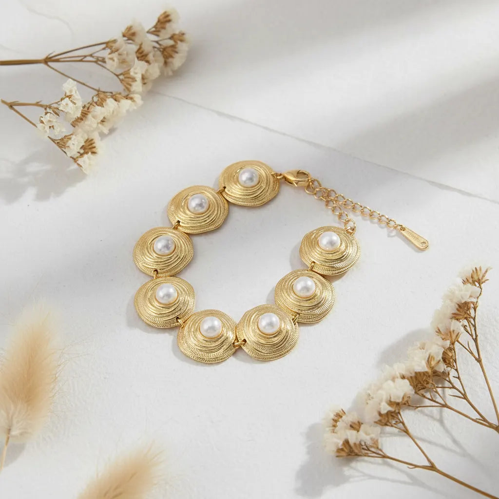 The Hera pearl medallion bracelet styled beautifully with delicate dried flowers, emphasizing its timeless, vintage-inspired aesthetic.