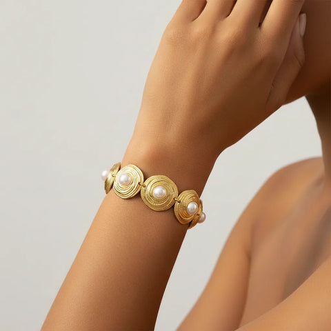 Detailed shot of The Hera Bracelet on a model's arm, demonstrating how the gold medallions articulate and wrap comfortably around the wrist.
