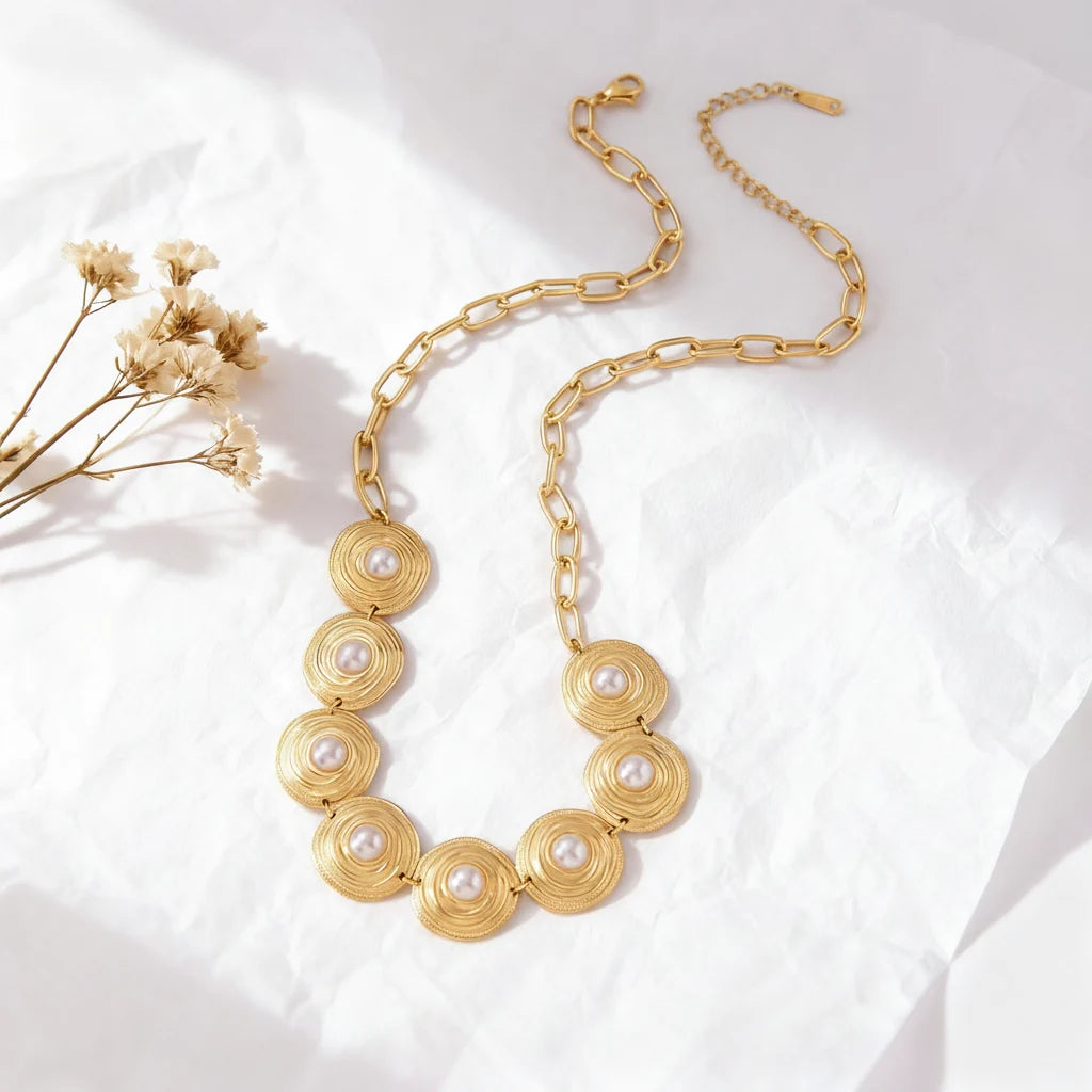 An artistic flat lay of The Hera statement collar necklace, styled with delicate dried flowers to emphasize its vintage, heirloom-quality aesthetic.
