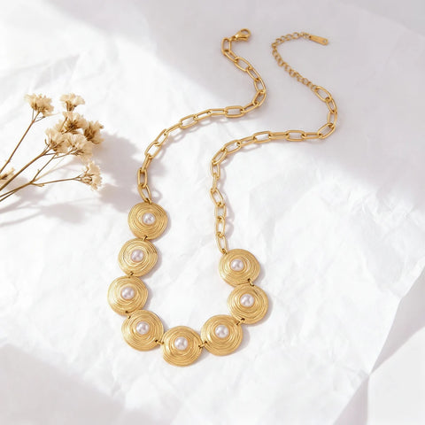 An artistic flat lay of The Hera statement collar necklace, styled with delicate dried flowers to emphasize its vintage, heirloom-quality aesthetic.
