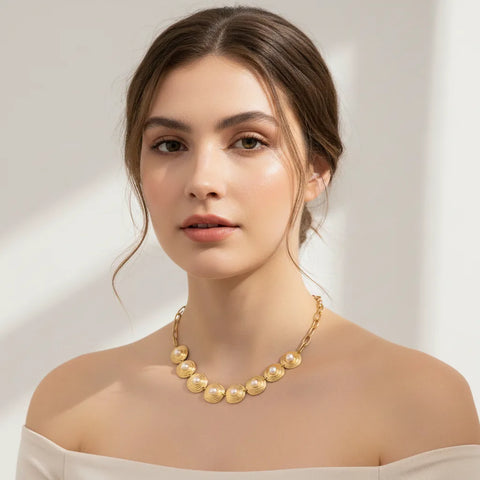 A stunning portrait of a model wearing The Hera pearl collar, embodying a regal and powerful queenly aesthetic perfect for a special occasion.