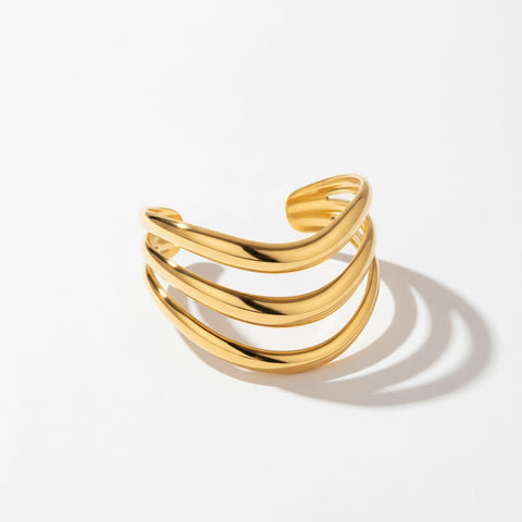 Sculptural organic shape gold open bangle minimalist statement piece.