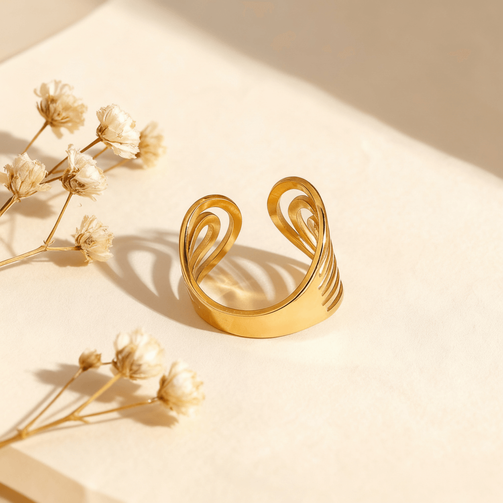 A side profile view of the sculptural Liquid Gold Ring standing on its edge. This angle emphasizes the significant width of the band and the three-dimensional height of the open loops that rise from the surface.