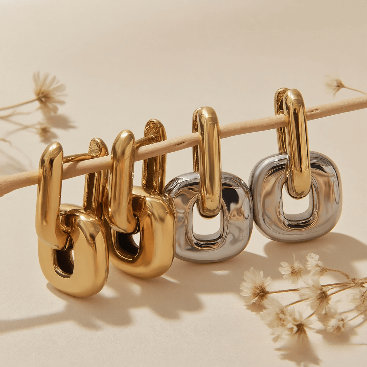 Urban Link Earrings — bold link earrings in polished gold/dual-tone on neutral background, modern statement jewelry.