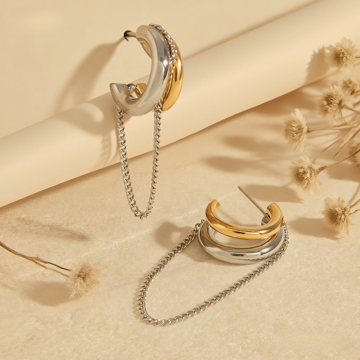 Luxe Layered Chain Hoops in two-tone gold and silver with a chunky C-shape and a dangling silver chain.