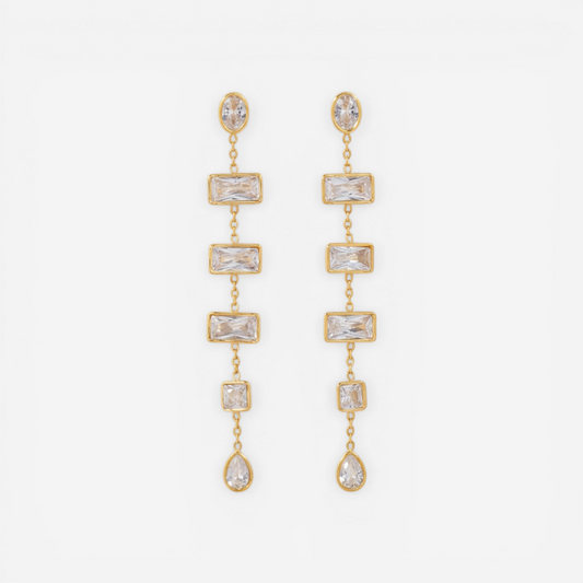 Pair of long gold linear earrings with rectangular and teardrop cubic zirconia stones.