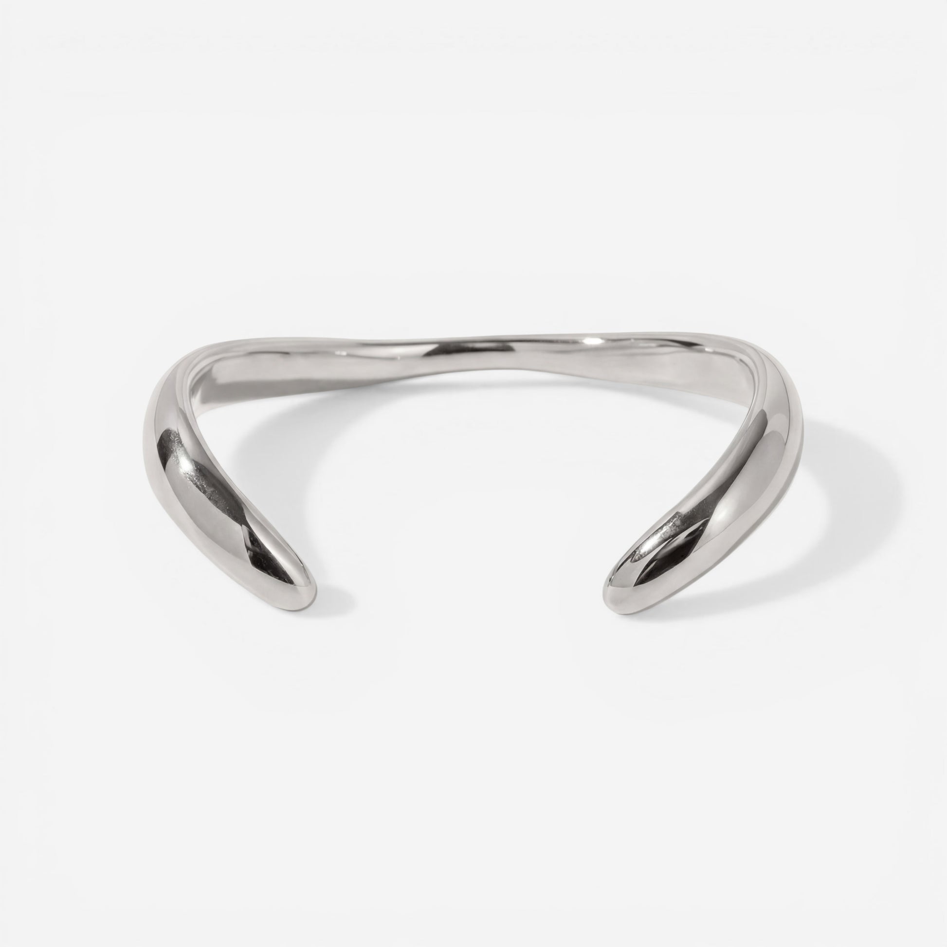 Silver sculptural wave bangle bracelet high polish stainless steel modern jewelry.