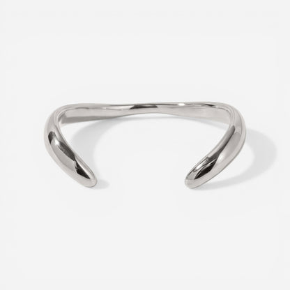 Silver sculptural wave bangle bracelet high polish stainless steel modern jewelry.