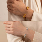 Lifestyle photography of woman wearing organic silver wave bangle bracelet modern style.