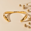 Minimal Wave Open Bangle — sculptural open bangle with wave curve in gold or dual-tone, modern minimalist bracelet.