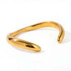Gold organic wave open cuff bracelet waterproof stainless steel liquid metal design.