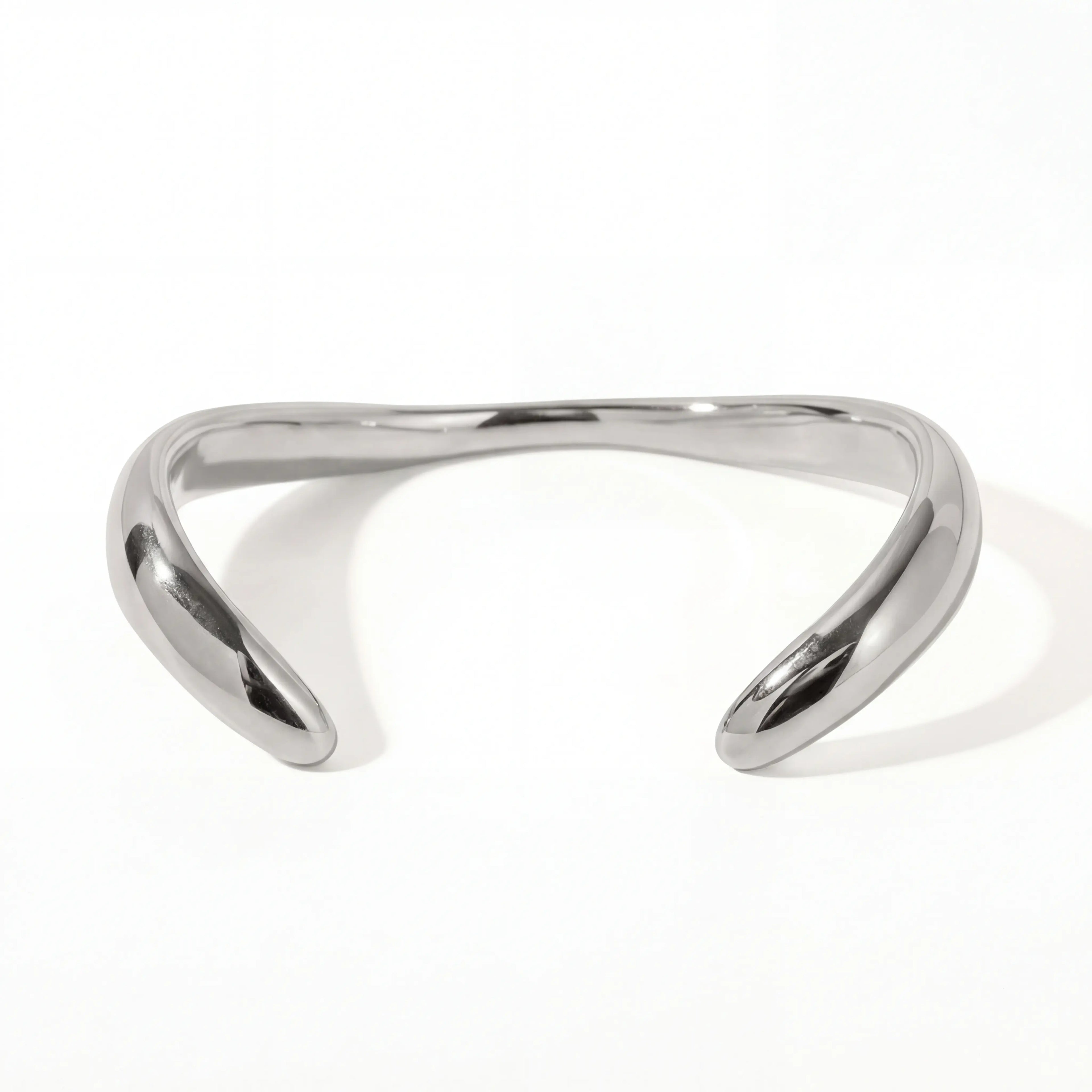 Silver sculptural wave bangle bracelet high polish stainless steel modern jewelry.