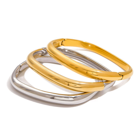 Stack of three minimalist square hinge bangles in gold and silver waterproof jewelry.