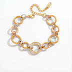 Mixed metal interlocking link bracelet two-tone gold and silver waterproof stainless steel.