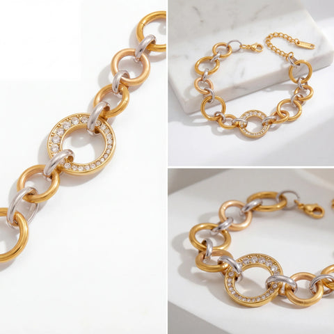 Aesthetic flat lay details of two-tone gold and silver link bracelet with pave crystal ring.