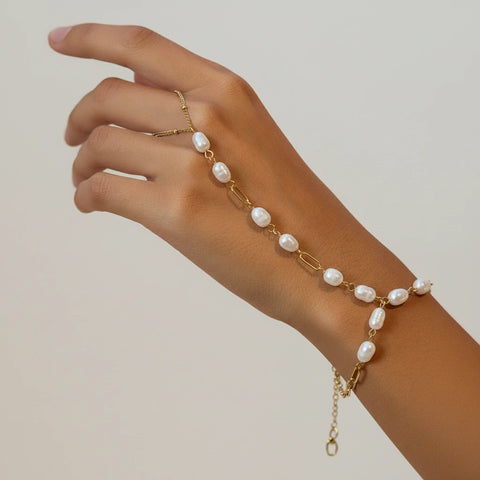 Side view of a model's wrist wearing The Nereid Hand Chain, highlighting the adjustable bolo-style clasp for a perfect, comfortable fit.