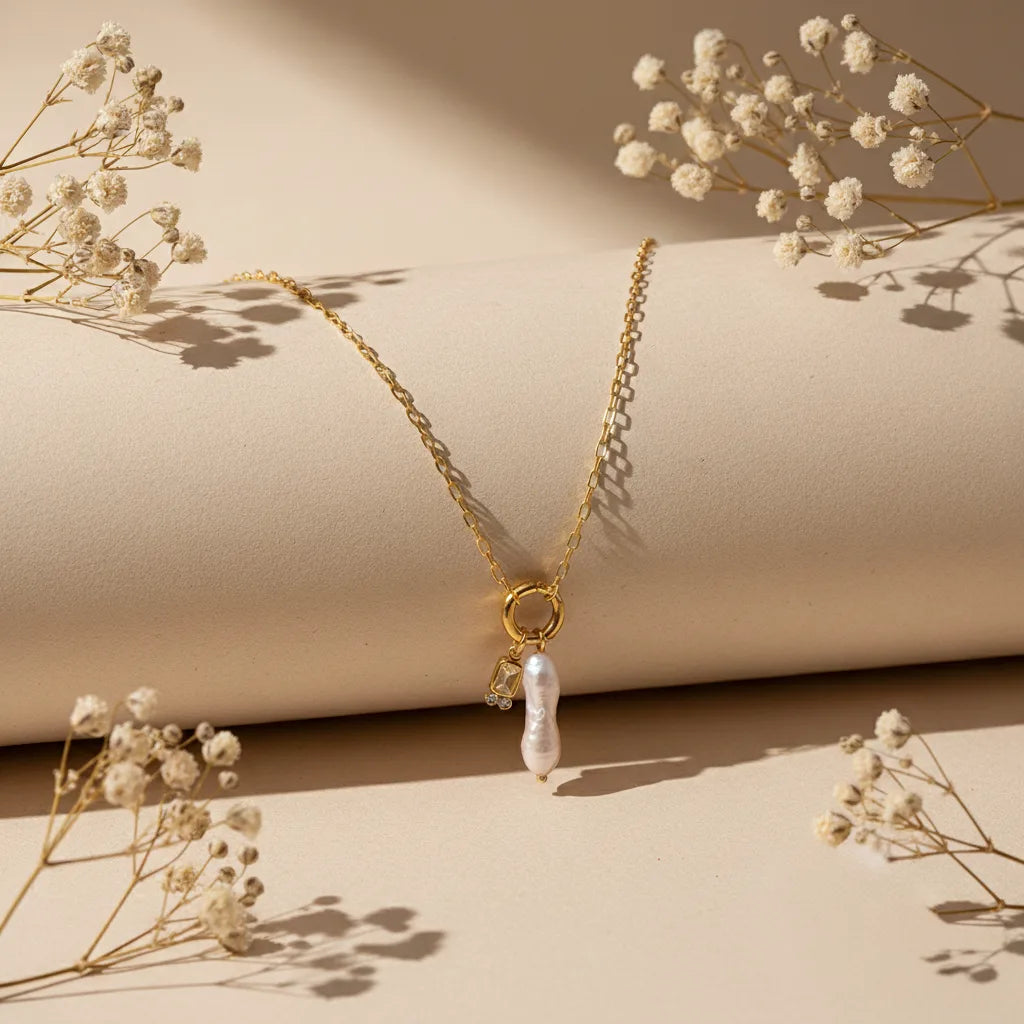 The Astoria Necklace for November, featuring a warm and sunny citrine yellow birthstone charm, styled artfully with dried flowers.