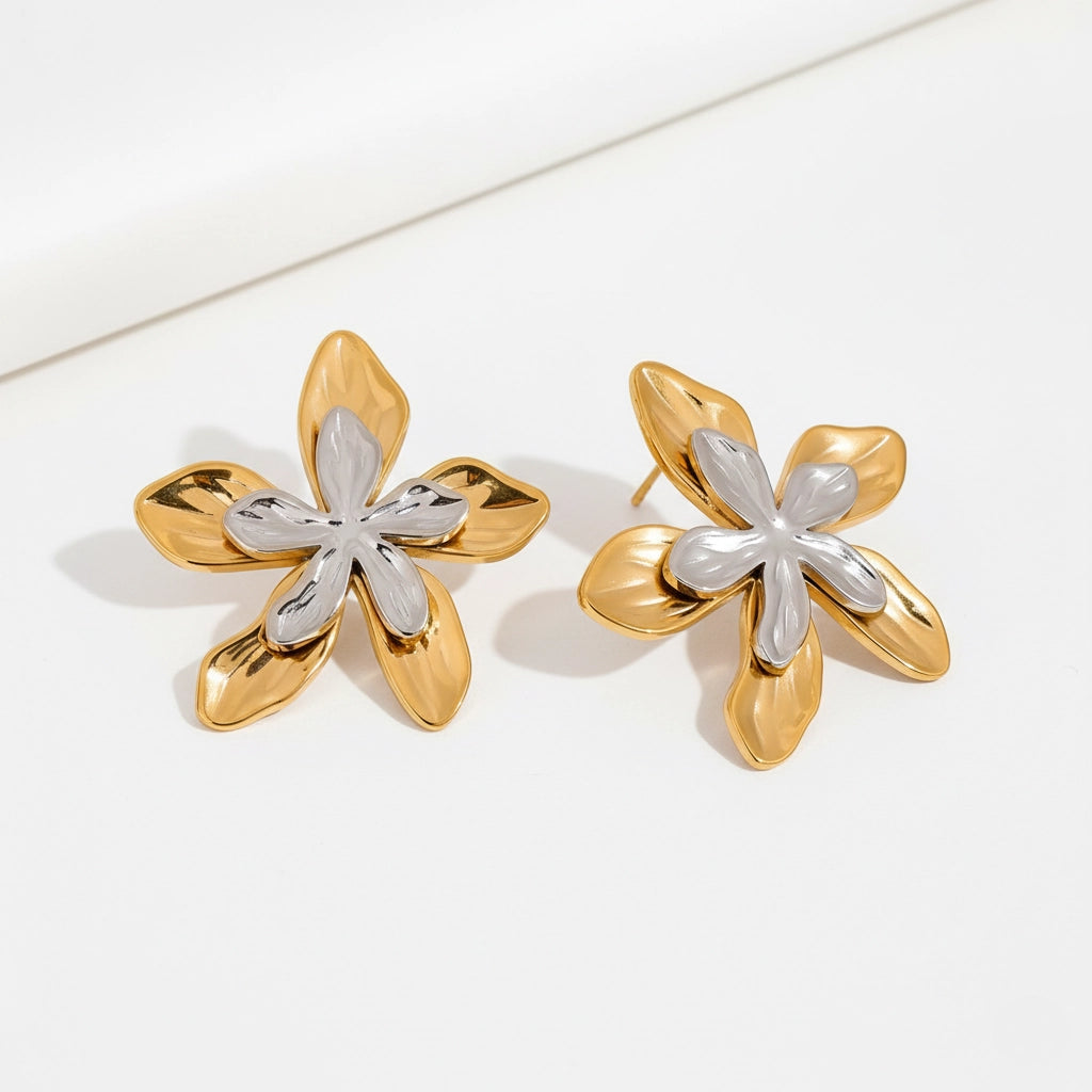 Mixed metal two-tone floral stud earrings gold and silver contrast design.