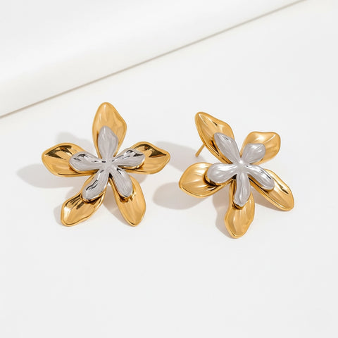 Mixed metal two-tone floral stud earrings gold and silver contrast design.