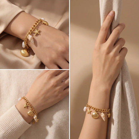 Elegant styling of gold pearl and shell charm bracelet on light skin model.