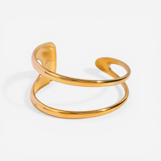 Organic double-wave open cuff bracelet gold stainless steel sculptural design.