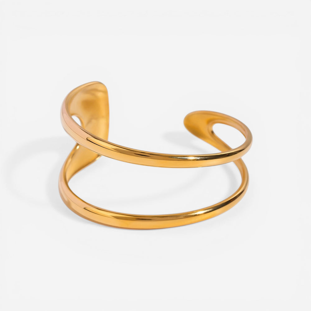 Organic double-wave open cuff bracelet gold stainless steel sculptural design.