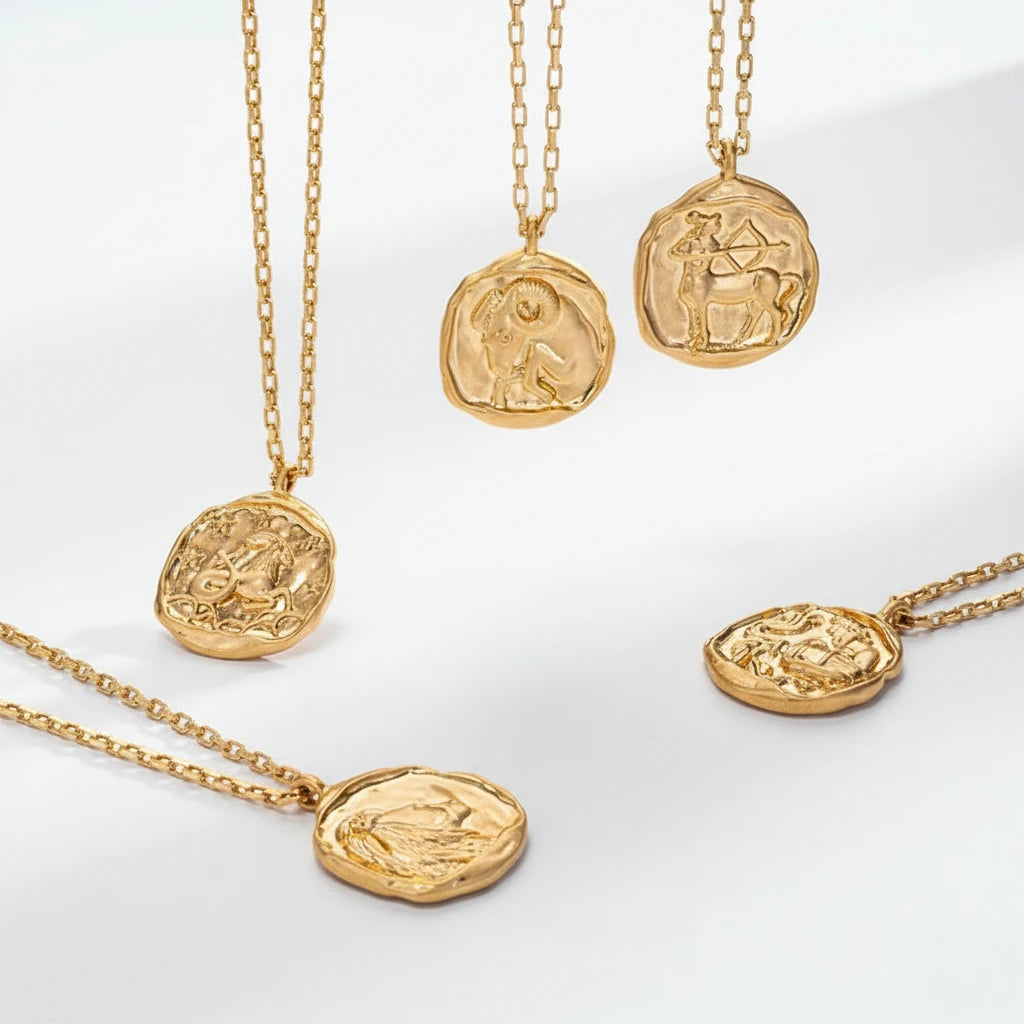 Aesthetic display of irregular shaped gold coin pendants vintage style waterproof jewelry.
