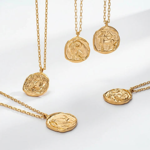 Aesthetic display of irregular shaped gold coin pendants vintage style waterproof jewelry.