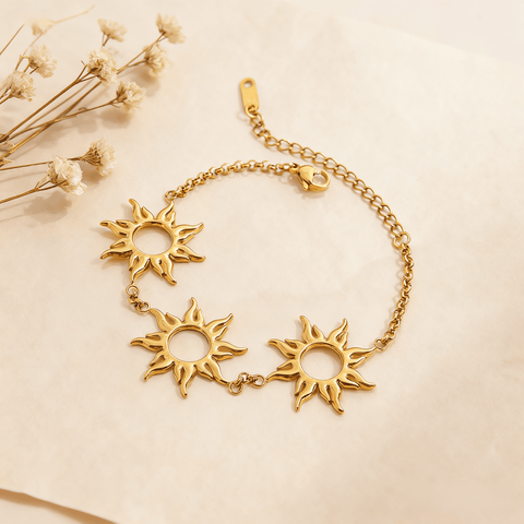 Luminova Radiant Sun Charm Bracelet with detailed sunburst pendant on a clean gold white background.