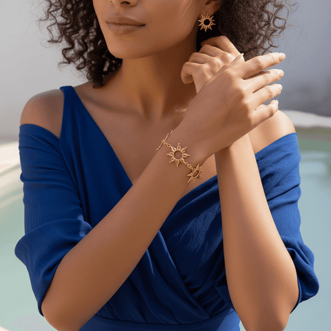 Radiant Sun Charm Bracelet worn on a female wrist, showcasing the boho jewelry stack with other gold bracelets.