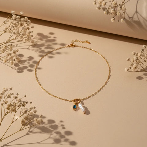 A detailed view of the deep blue September birthstone (sapphire) on The Astoria Necklace, highlighting its regal color and elegance