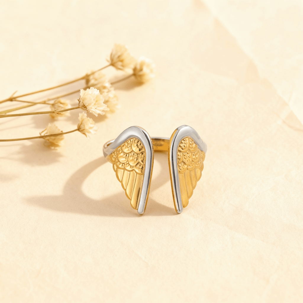 An artistic close-up of the two-tone Seraphina Ring, highlighting the polished silver edges on the detailed golden wings.