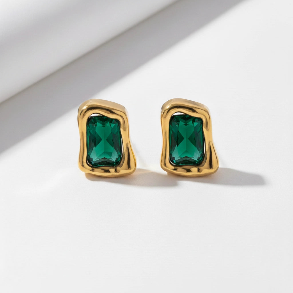 Emerald green gemstone rectangular stud earrings with textured gold setting.