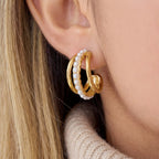 Close up of woman wearing Siren triple hoop earrings with pearl and gold bands stacked look.