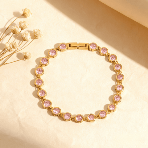 Sweetheart Pink Tennis Bracelet featuring round pink crystals in an 18k gold plated bezel setting, shown on a clean white background.