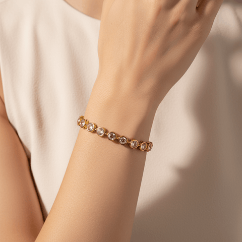Model wearing the Sweetheart Pink Crystal Tennis Bracelet stacked with a gold watch.